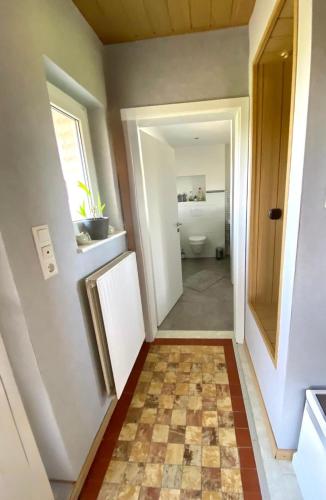 a bathroom with a toilet and a tile floor at Ferienwohnung Schöne Aussicht in Nieheim