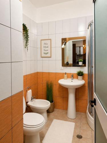 a bathroom with a toilet and a sink at Avela Beach Apartments in Durrës