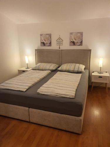 a bedroom with a large bed with two lamps on it at Villa-Panorama in Drage