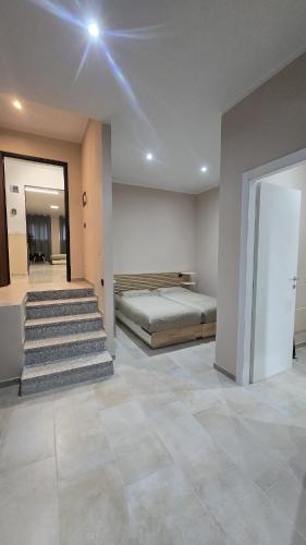 a bedroom with a bed and stairs in a room at B&B House Novara in Novara