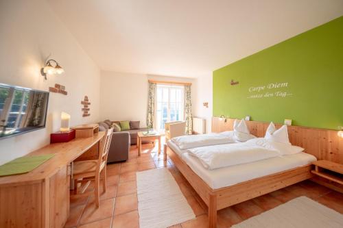 a bedroom with a bed and a table and a desk at Birkenhof Loipersdorf in Loipersdorf bei Fürstenfeld