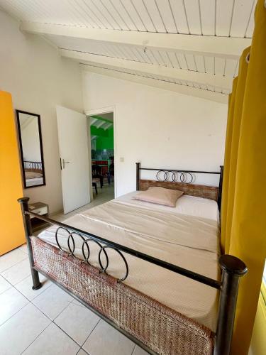 a bedroom with a large bed in a room at Corossole in Bouillante