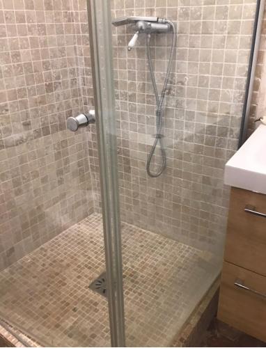 a shower with a glass door in a bathroom at Beautiful studio with a beautiful view in Lurs