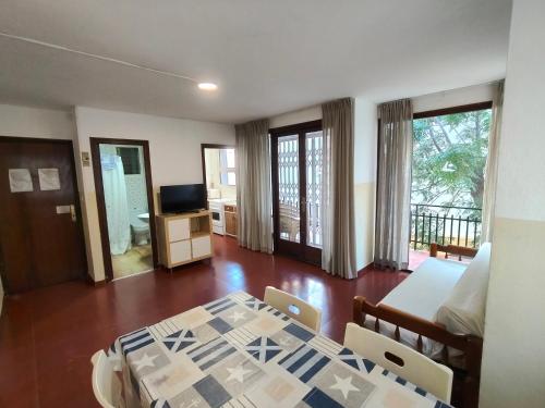 a bedroom with a bed and a table and chairs at Lamoga Ona in Torredembarra