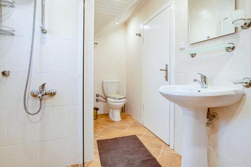 a white bathroom with a sink and a toilet at Summerdays in the Med in Fethiye