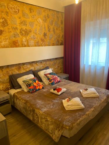 a bedroom with a bed with towels on it at Errik Luxury House in Faliraki