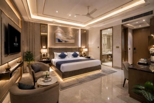 a bedroom with a bed and a desk and chairs at Hotel Velocity Near Terminal 3 Delhi International Airport With- Free Pickup in New Delhi