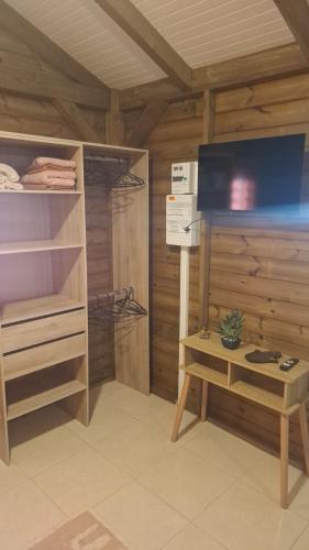a room with wooden walls and a closet with a table at bungalow détente in Capesterre-Belle-Eau
