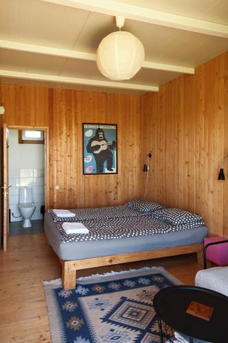 a bedroom with a bed in a wooden wall at Oasis Club Cottages in Udabno