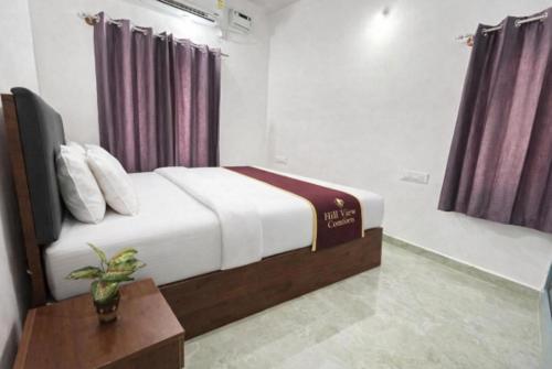 ein Hotelzimmer mit einem Bett und einem Tisch in der Unterkunft Hill View Comforts in Mysore
