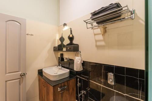 a bathroom with a sink and a mirror at Luxury 2BHK Villa Near Anjuna Beach, North Goa in Anjuna