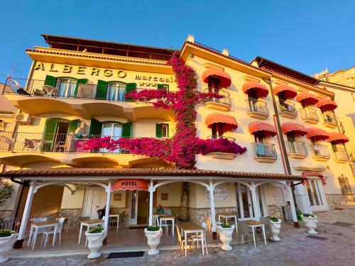 a yellow building with a bunch of flowers on it at Hotel Marconi in Sperlonga