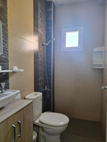 a bathroom with a toilet and a sink and a shower at Andalus Sunset in Tangier