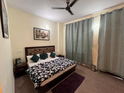 a bedroom with a bed and a ceiling fan at Hotel AAA And Restaurant in Gupta Kāshi