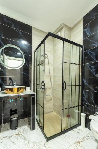a bathroom with a shower and a sink at Shire Küçükköy in Ayvalık