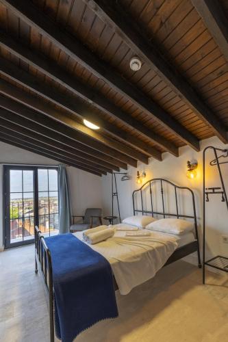 a bedroom with two beds and a large window at Shire Küçükköy in Ayvalık