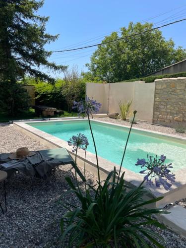 a swimming pool in the backyard of a house at La Bastide Chamarrée in Camaret-sur-Aigues