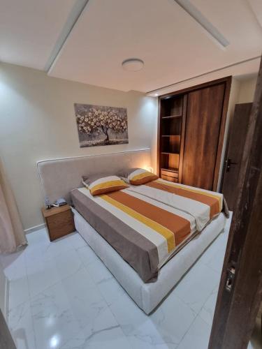 a bedroom with a large bed in a room at Modern flat in a central location in Kenitra in Kenitra