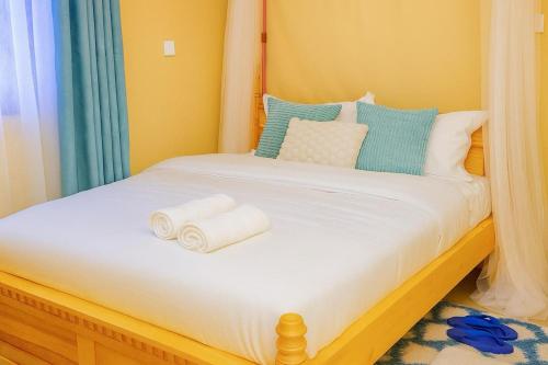 a bedroom with a bed with towels on it at Shwari Home Stays in Kisii