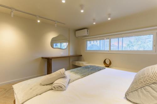 a bedroom with a large bed and a window at Happy Cactus 1BR Apartment In Batroun Souks in Batroûn