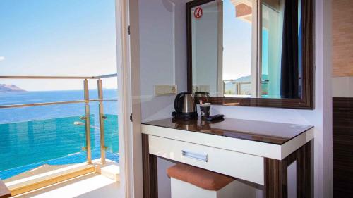 a bathroom with a sink and a large window at Kas Maki Hotel in Kaş