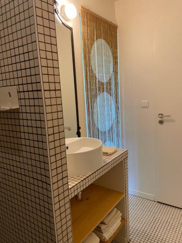 a bathroom with a sink and a mirror at Maison Caramel in Condorcet