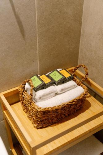 a basket of towels on a table in a bathroom at Atman Eco Lodge in Gliki