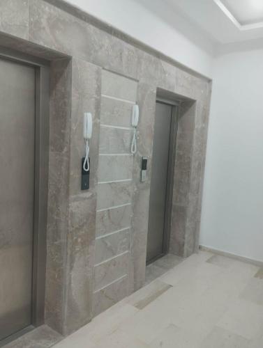 a stone wall with phone booths in a room at Nozeht el soltan in Potinville