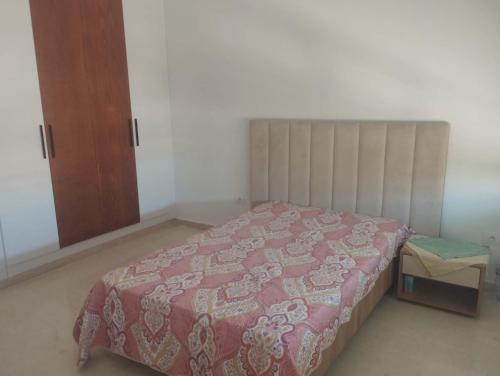 a bedroom with a bed and a wooden cabinet at Nozeht el soltan in Potinville