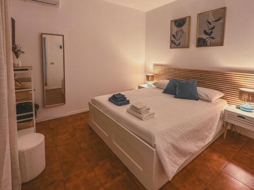 a bedroom with a large bed and a mirror at La La Land in Letojanni