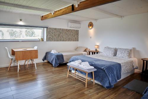 a bedroom with a bed and a couch and a table at Quinta Da Estrada Winery Douro Valley in Peso da Régua
