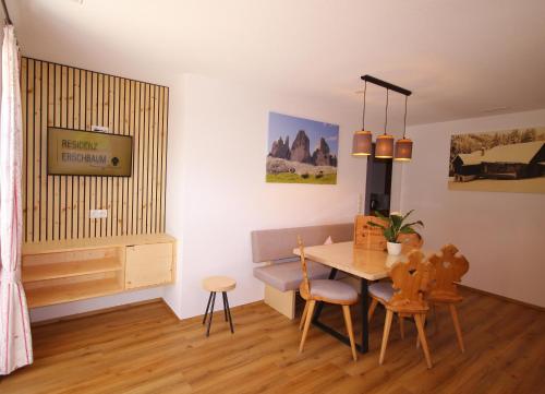 a living room with a table and a dining room at Residenz Erschbaum in Valdaora