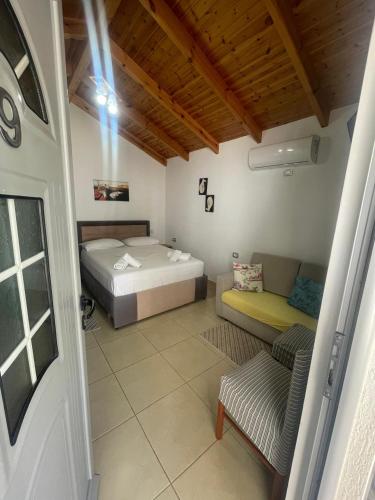 a room with two beds and a couch in it at Villa Oden in Ksamil