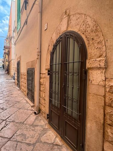 an entrance to a building with a large metal door at MaryClouBert-Home in Molfetta