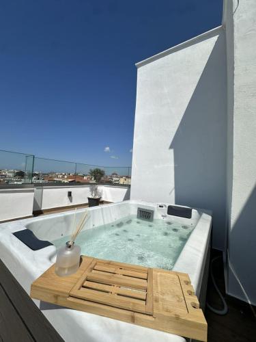 a hot tub sitting on top of a building at Diamond Suite in Nea Kallikrateia