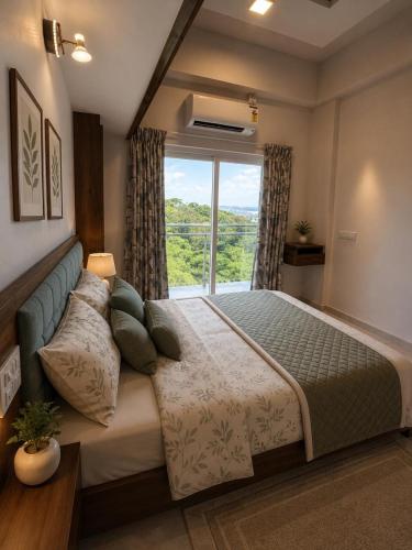 a bedroom with a large bed with a window at Neelaashray Sea view apartment in Ratnagiri