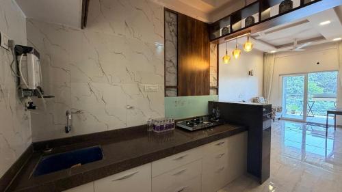 a kitchen with a sink and a counter top at Neelaashray Sea view apartment in Ratnagiri