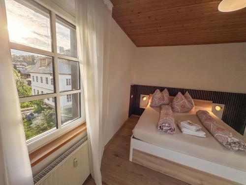 a small bedroom with a bed and a window at Seebühnenblick in Seeham