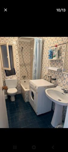 a bathroom with a toilet sink and a washing machine at ,1 habitacion in Esplugues de Llobregat
