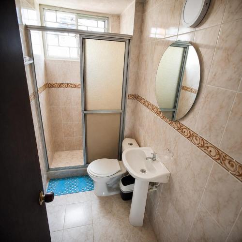 a bathroom with a toilet and a sink and a shower at Troya 701 in Gaira