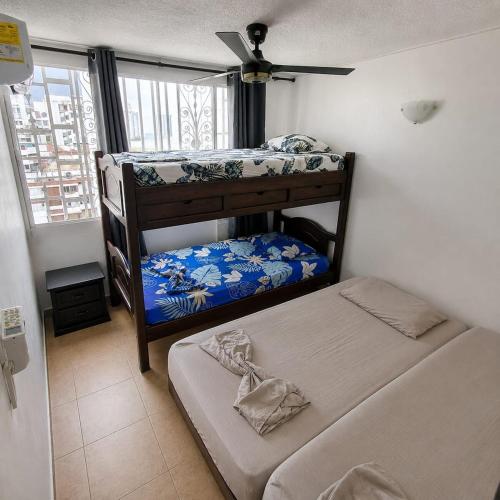 a bedroom with two bunk beds and a window at Troya 701 in Gaira