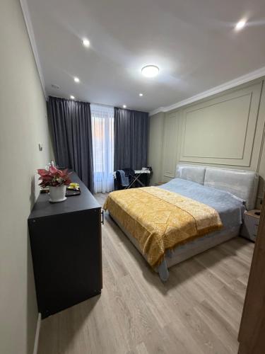a bedroom with a bed and a table with flowers on it at Tabigat Hotel & Spa in Alga