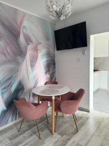 a dining room with a table and two chairs at Apartament nad jeziorem in Lubkowo