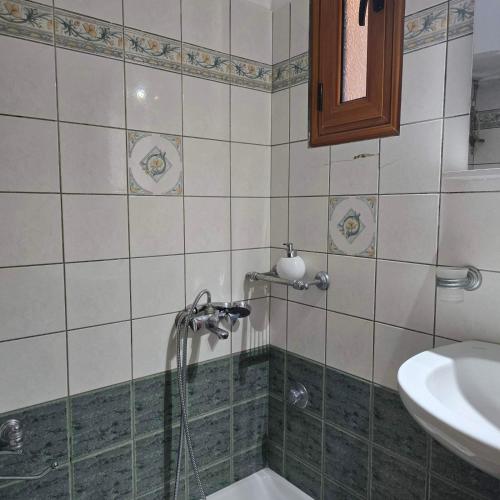 a bathroom with a shower and a sink at Marmari Sunset View in Marmari