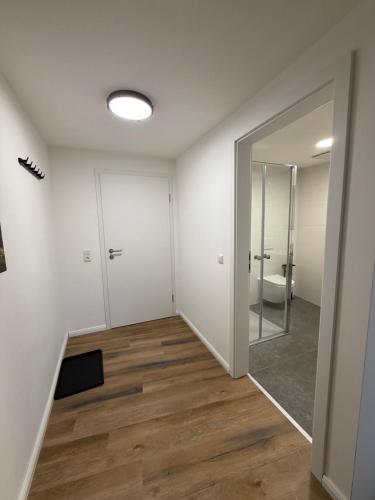 a room with a bathroom with a toilet and a mirror at Bartenwetzer Schleusenhaus 1 in Melsungen