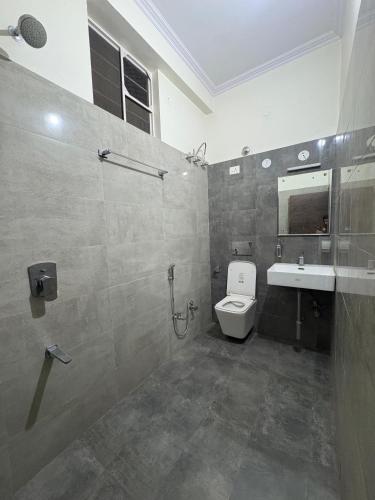 a bathroom with a toilet and a sink and a shower at Entire 2Bhk Flat with a big Balcony in Jaipur