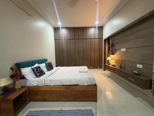 a bedroom with a bed and a wooden wall at Entire 2Bhk Flat with a big Balcony in Jaipur
