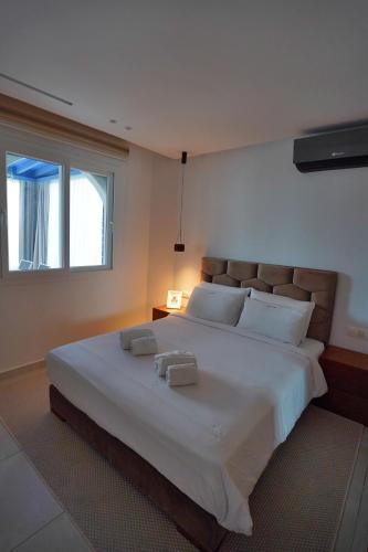 a bedroom with a large bed with two towels on it at InHome Apartment F2 in Cabo Negro