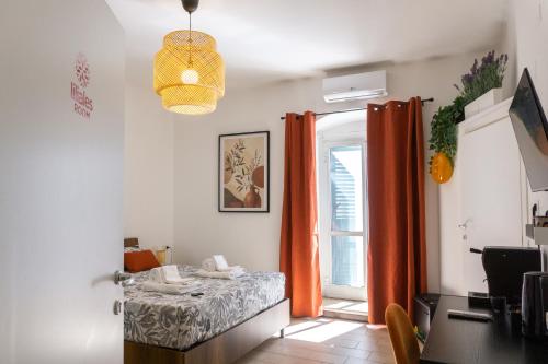 a dining room with orange curtains and a table at Room in Bloom Bed and Breakfast in Terlizzi