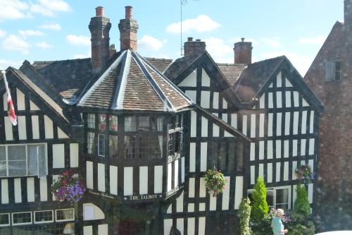an old black and white building with a roof at The Talbot Hotel in Ledbury